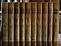 Green and Gold books on polished wood